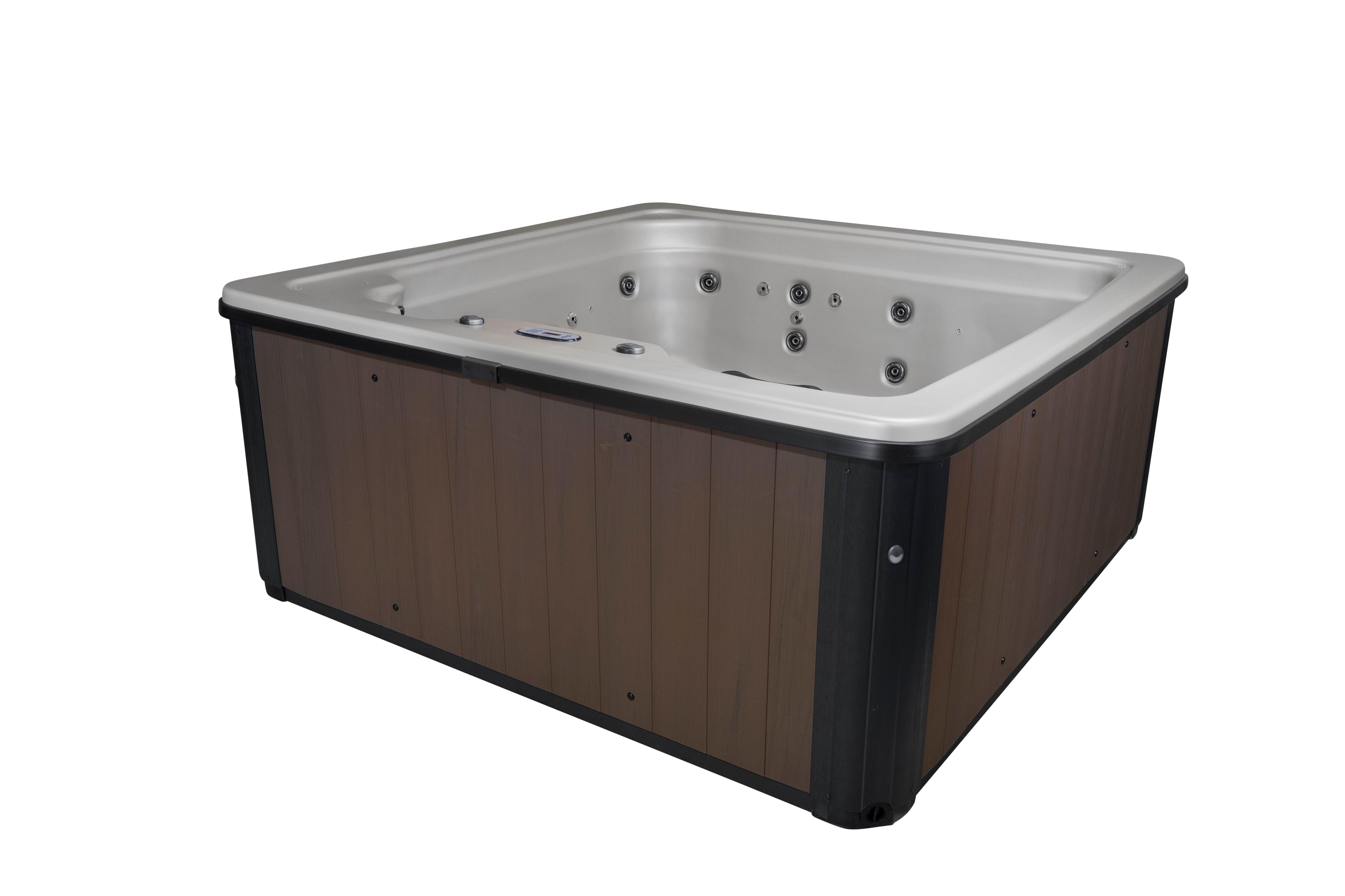 Exterior view of the Cyanna Valley Galaxy 6 Person 41-Jet Square Hot Tub Spa with Ozonator, surrounded by lush greenery and equipped with LED lighting and ergonomic seating for ultimate relaxation and comfort