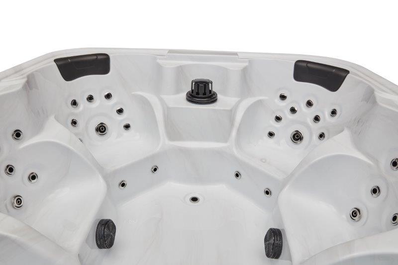 Relaxing in the luxurious Eclipse 6 Person Hot Tub Spa with 51 Jets & Bluetooth WS-192 amidst a serene outdoor setting