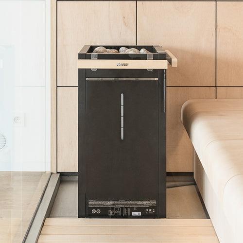 Harvia Virta Combi Series 90kW Sauna Heater installed in traditional wooden sauna room, side view