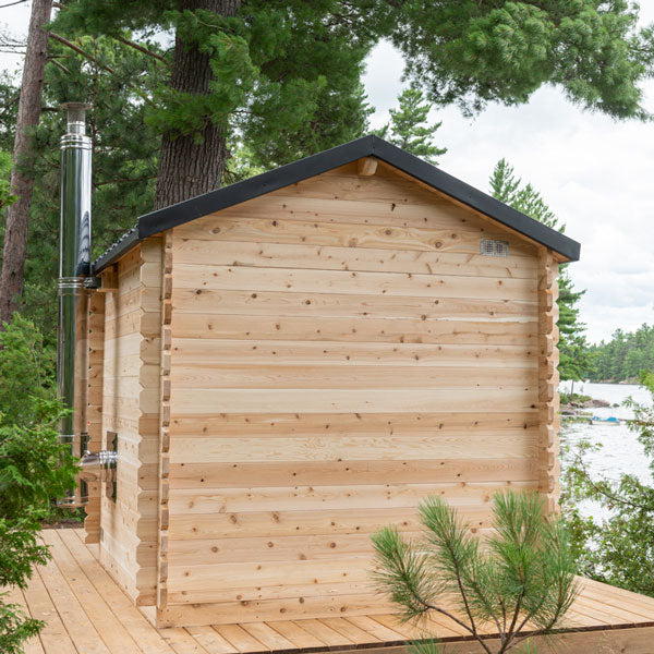 Rustic outdoor sauna made of natural wood, comfortably seating 6 people, with a porch for relaxation and socializing, the Georgian 6 Person Outdoor Cabin Sauna is perfect for enjoying the benefits of traditional sauna therapy in a serene outdoor setting