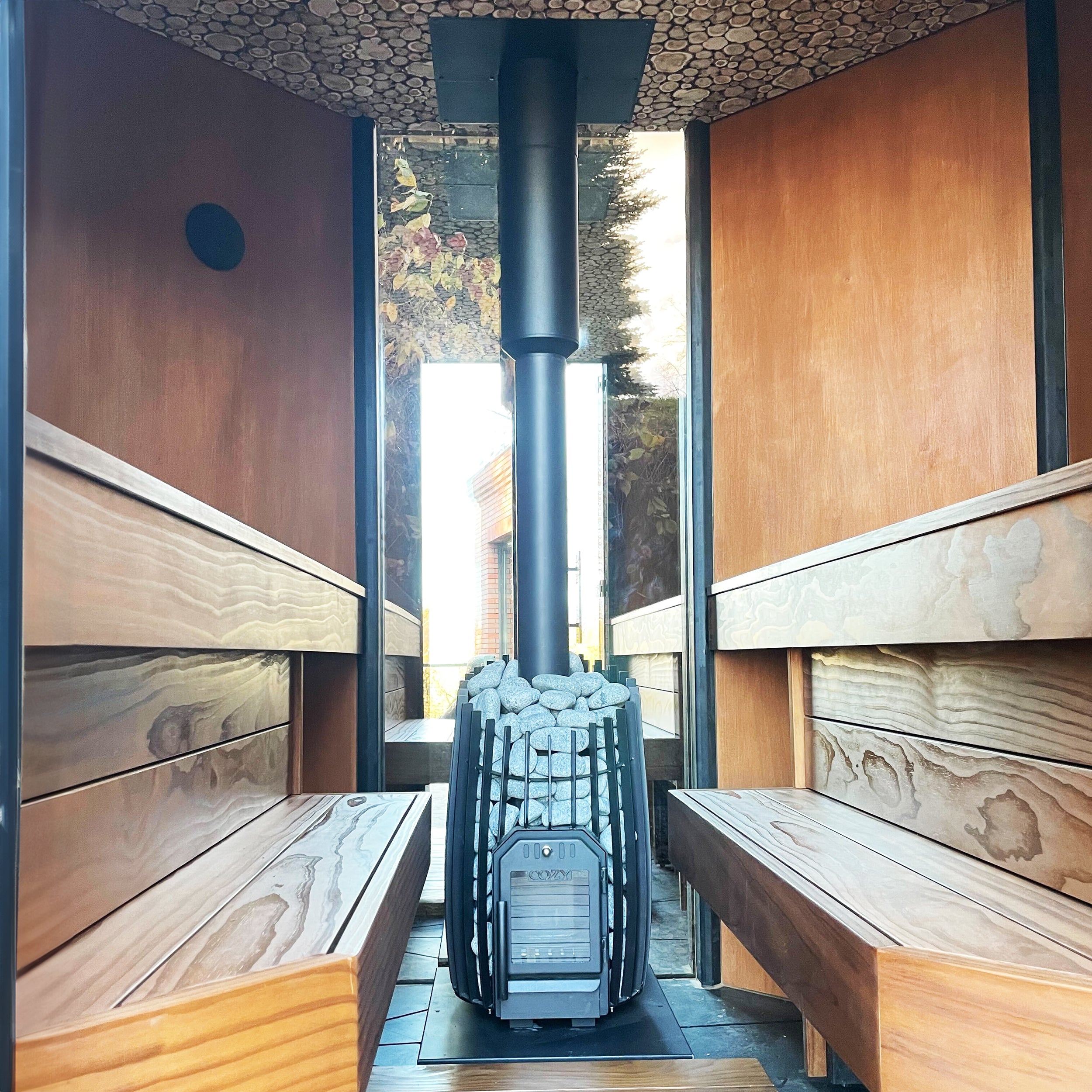 Cozy Heat SW Sauna Stove with stone surround and chimney